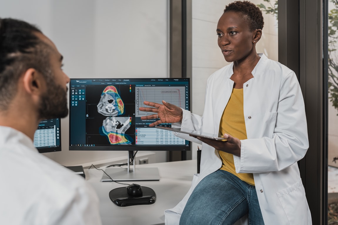 Clinicians reviewing medical imaging and data on a screen