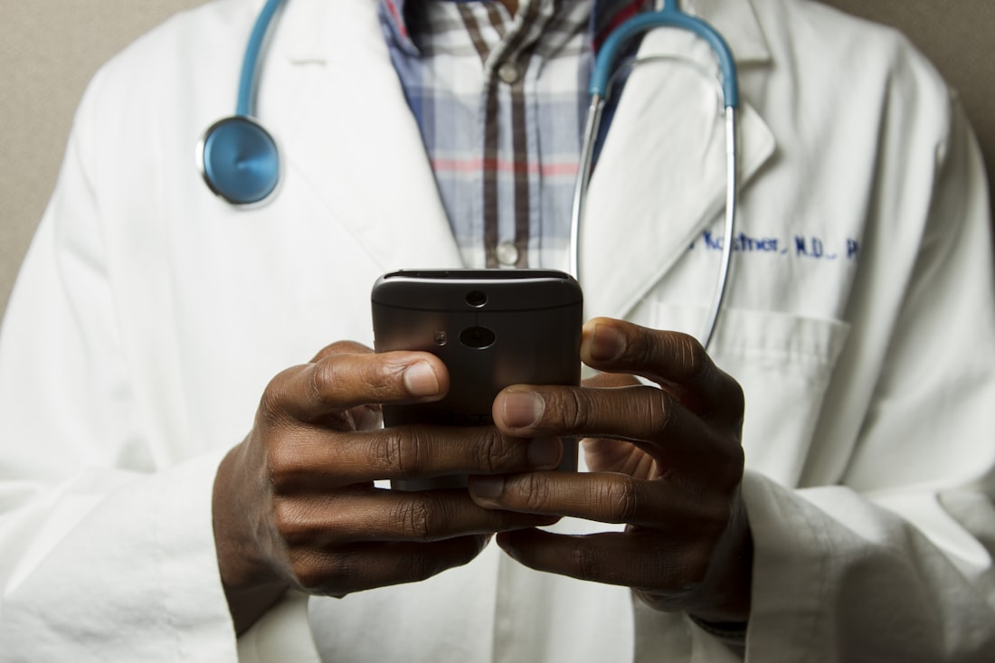 Clinician using a secure telemedicine app on a smartphone